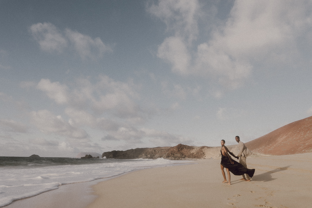 Couple walk along one of the beautiful beach of Las Conchas. 