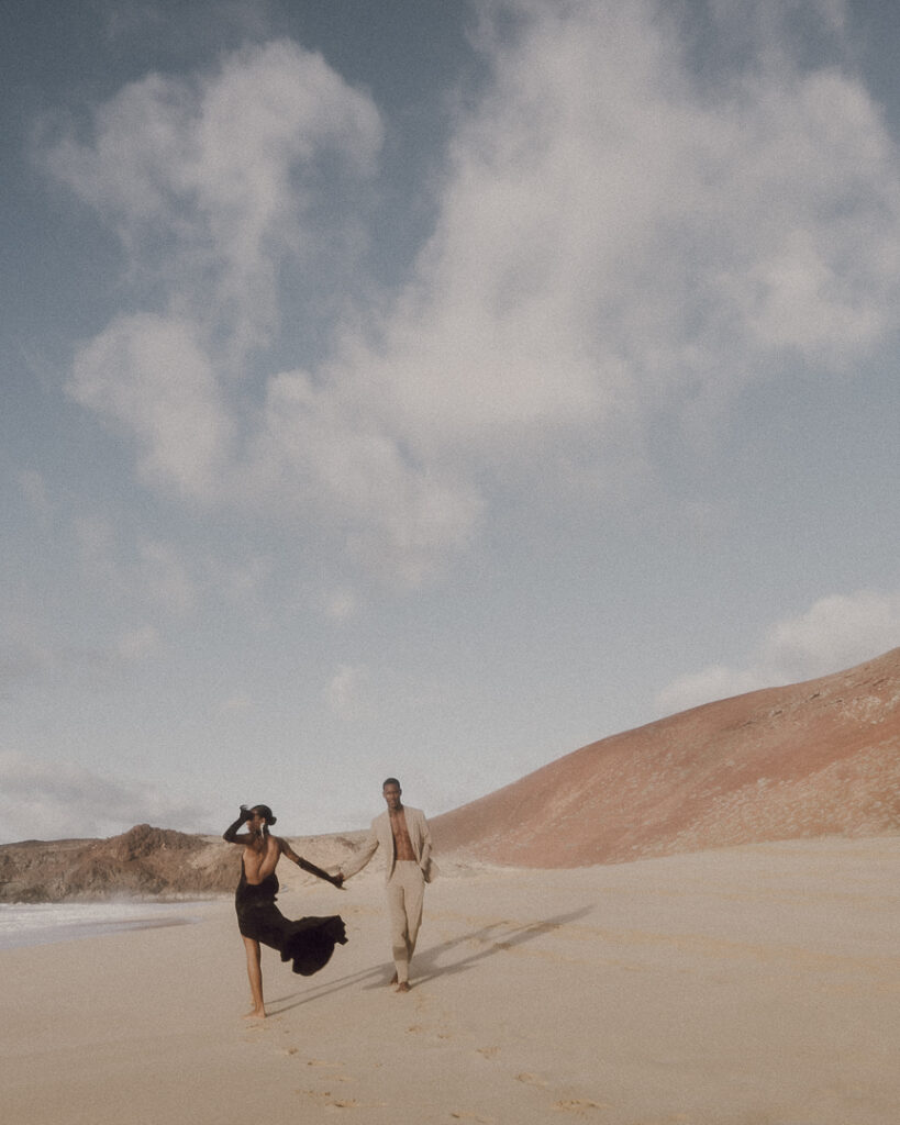 Couple walk along one of the beautiful beach of Las Conchas. 