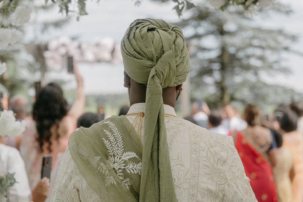 Groom in traditional indian wedding attire as seen from behind