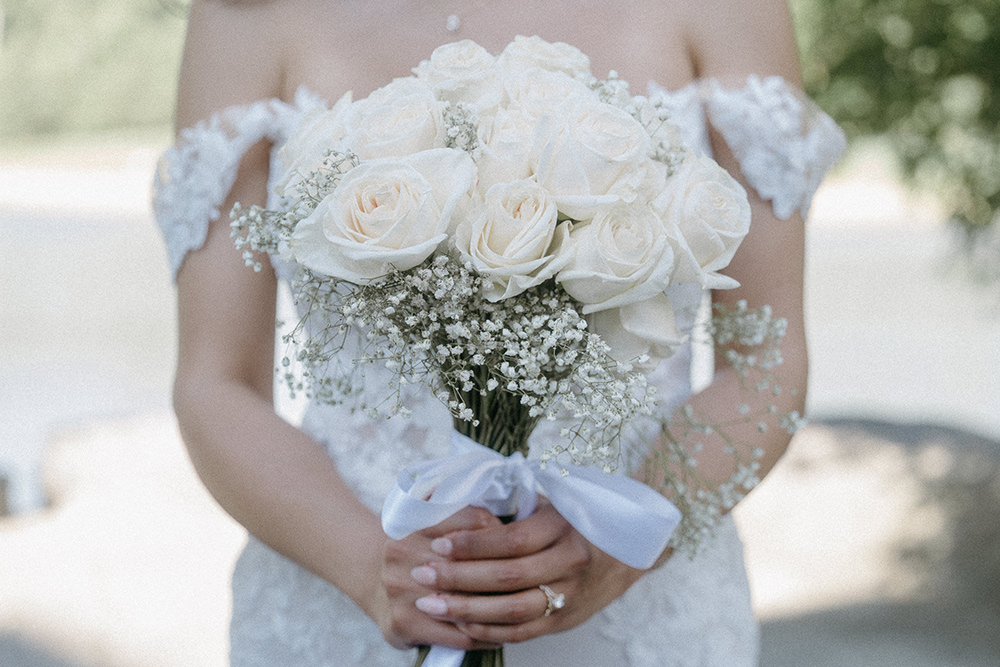 Bride holds modern floral arrangement 